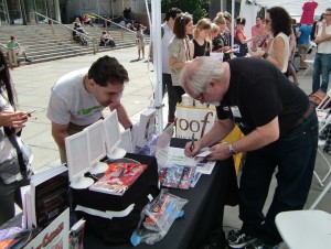 Rich White autographs a copy of Troubleshooters, Incorporated: Night Stalkings for a new fan.